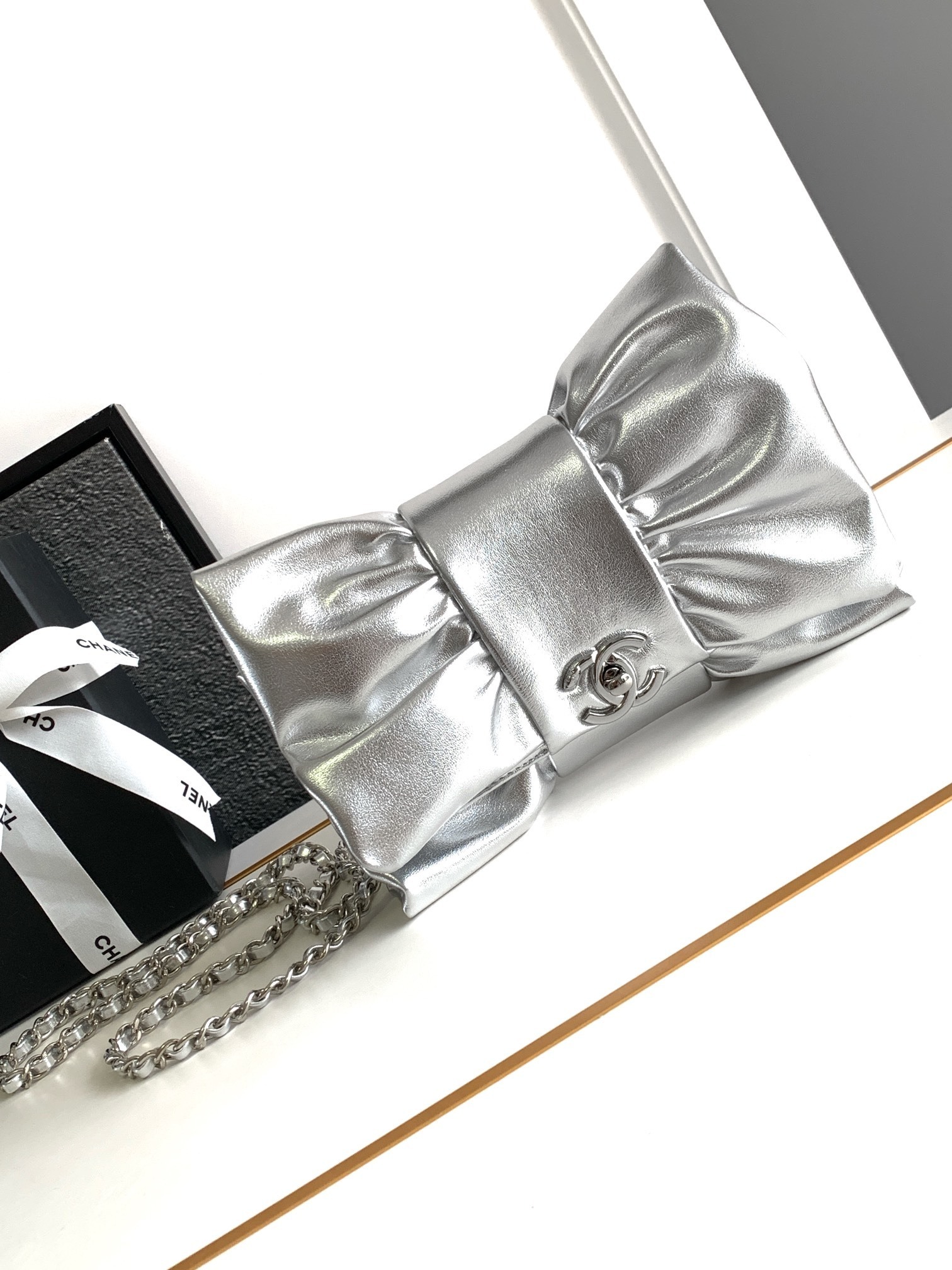 Chanel metallic silver ribbon clutch bag