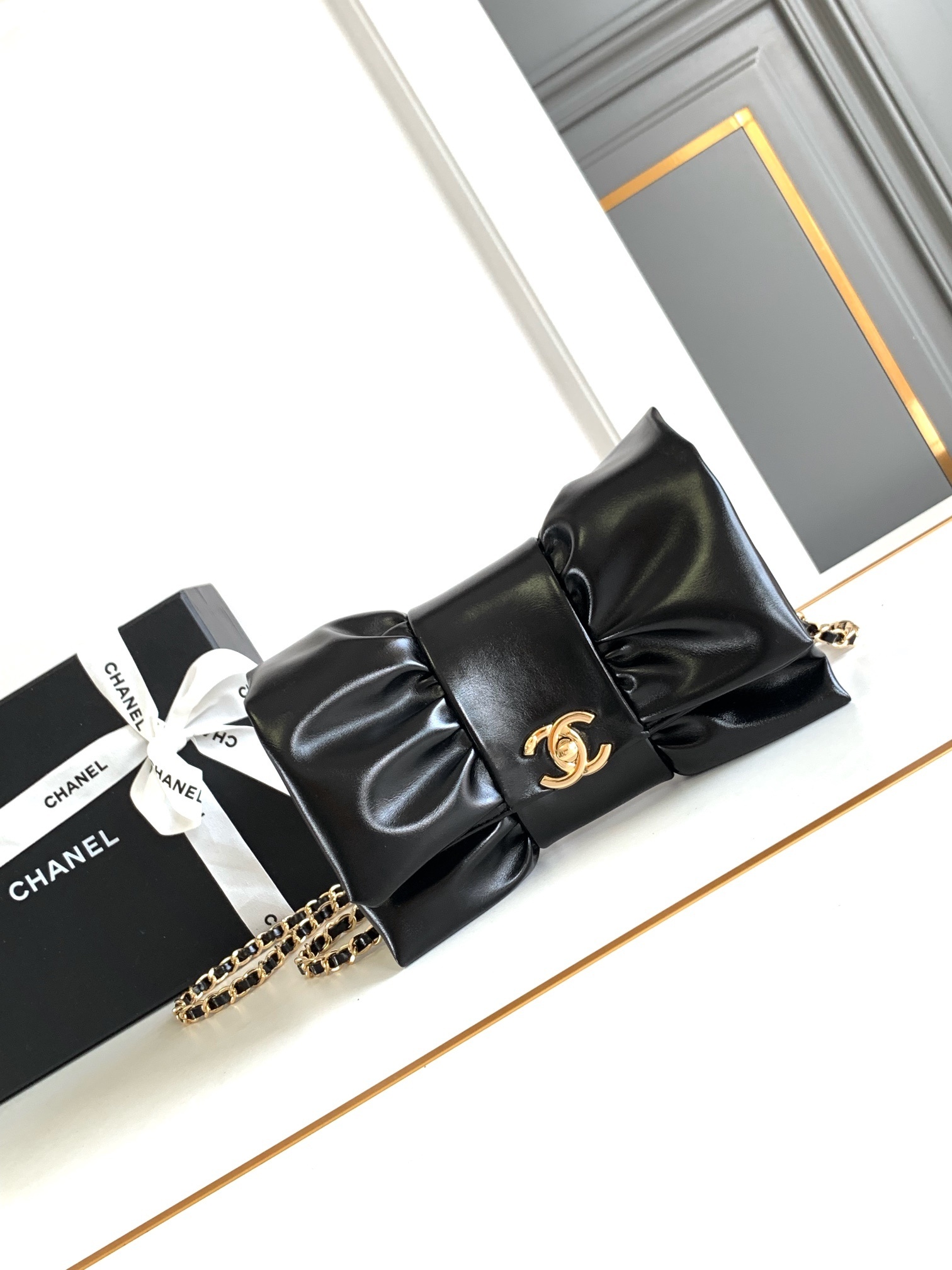 Chanel makeup bag with a bow and chain possibly a gift with purchase item clutch