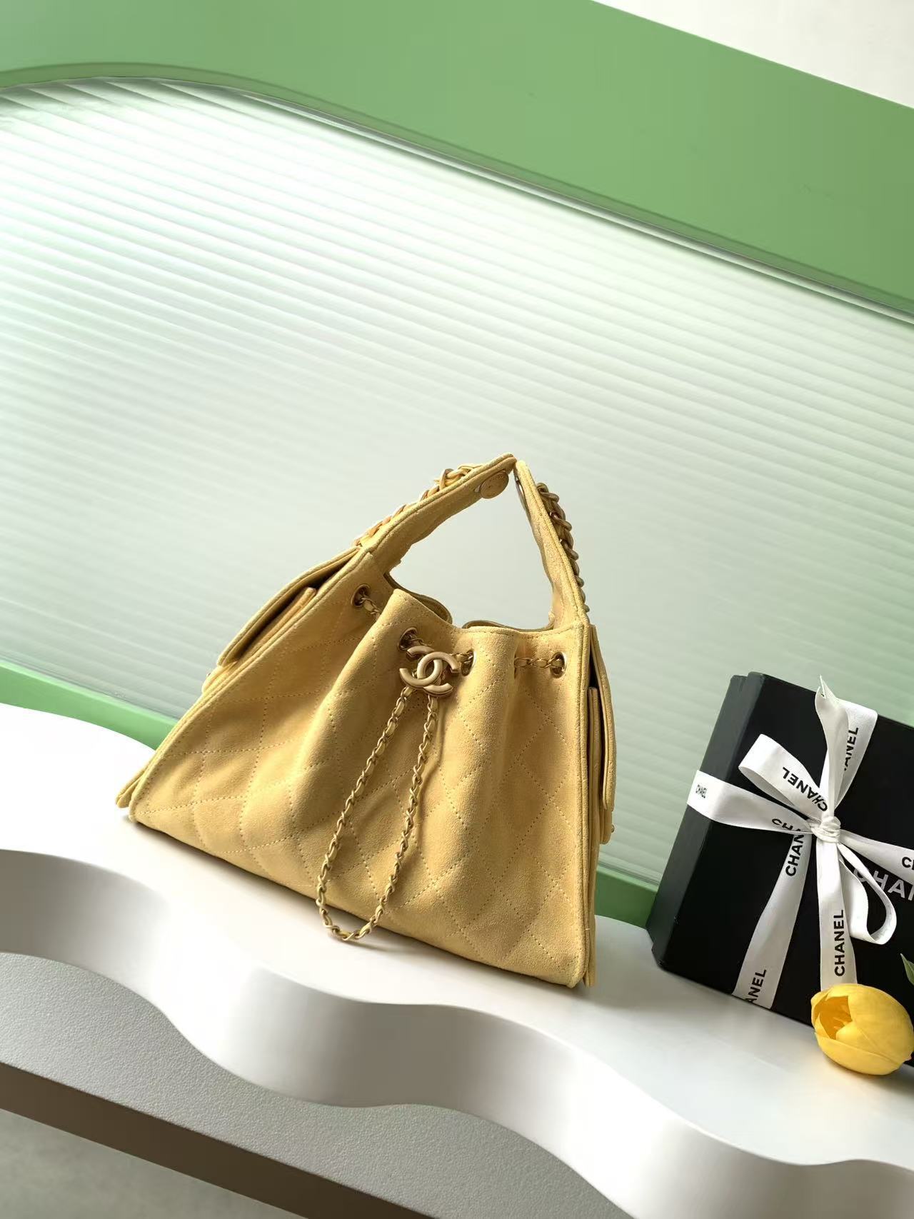 Chanel 25 hobo bag in a light beige or yellow suede material