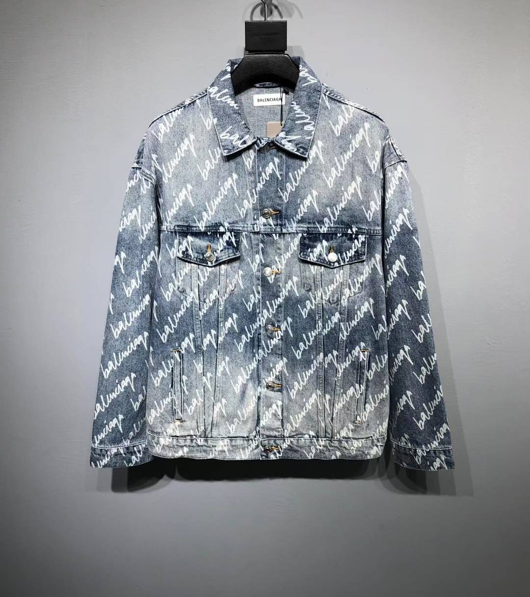 Balenciaga blue denim jacket featuring an all-over logo print and a washed finish