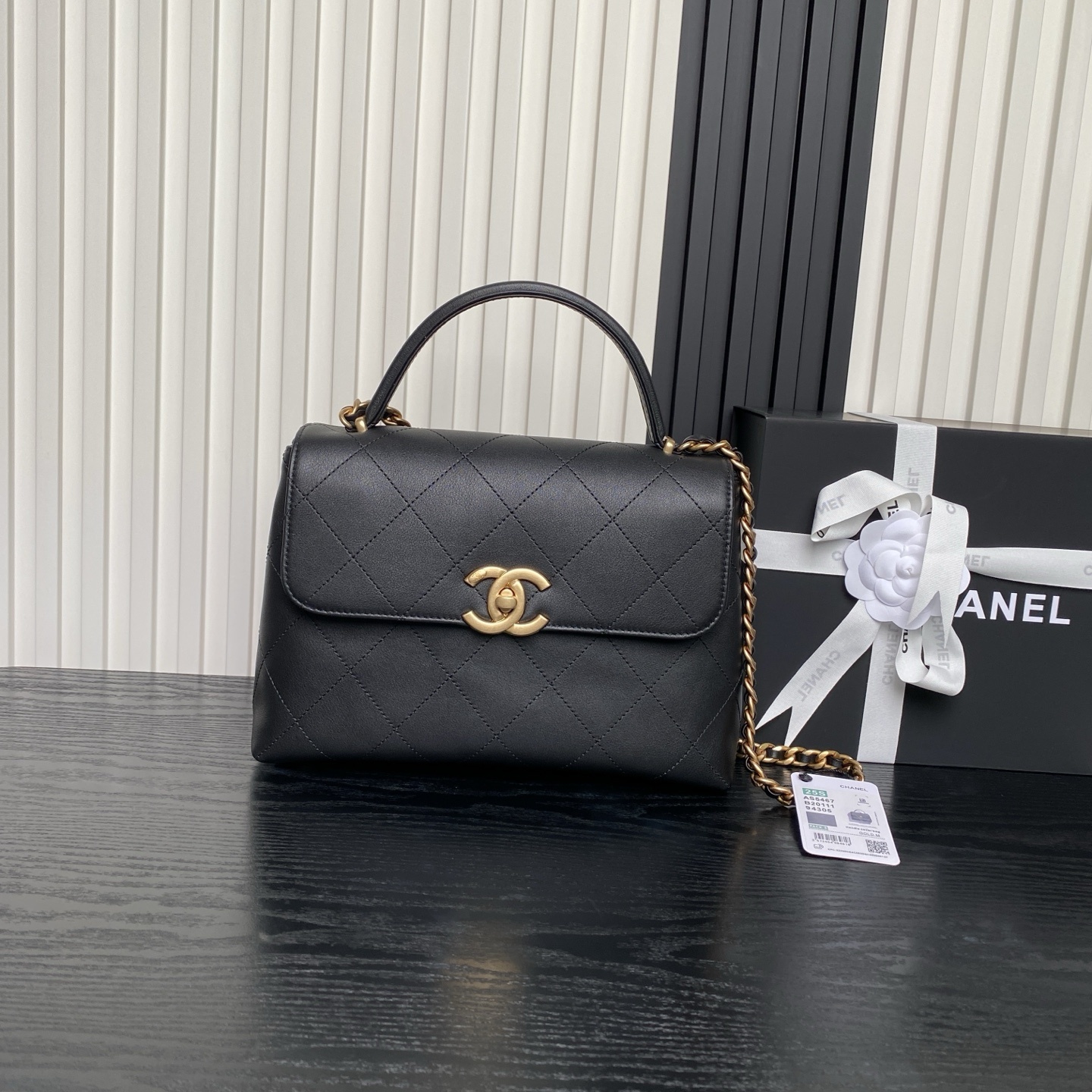 Chanel 25s handbag in black calfskin with golden accents.