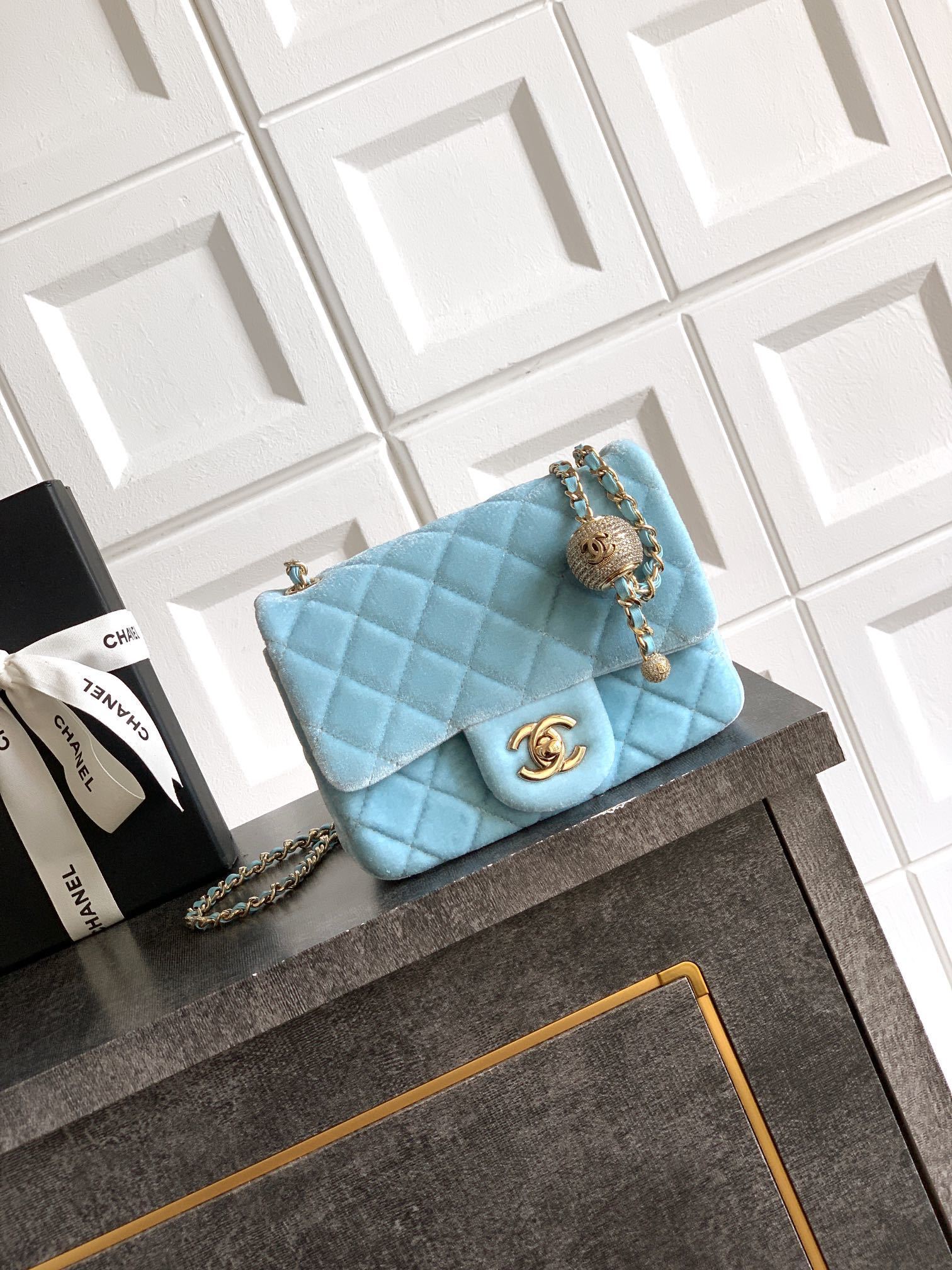Chanel mini flap bag in a light blue quilted leather or velvet finish
