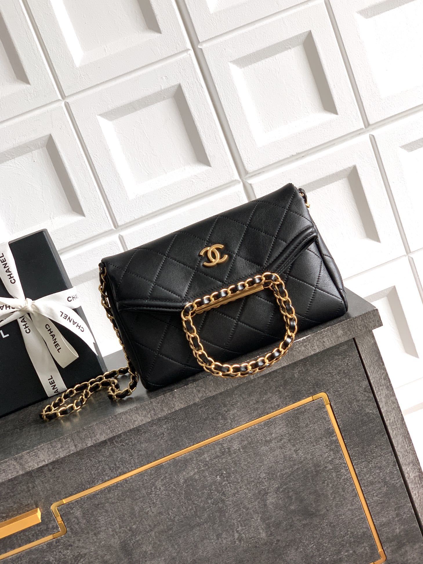 Chanel Mini Flap Bag with Top Handle in black lambskin and gold-tone metal hardware