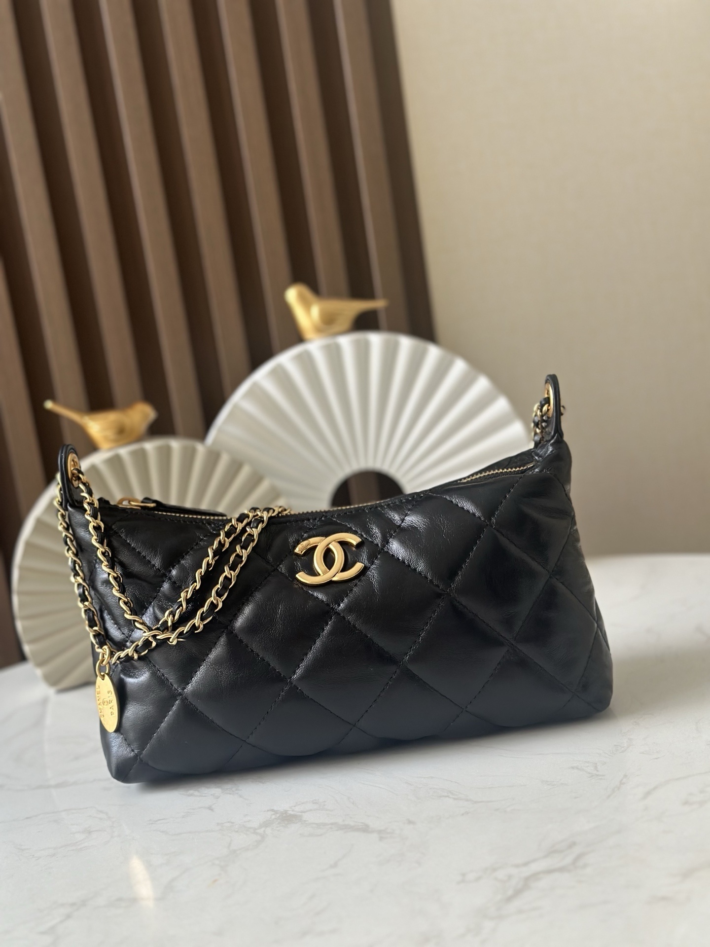 Chanel hobo bag in black quilted lambskin with gold-tone metal hardware