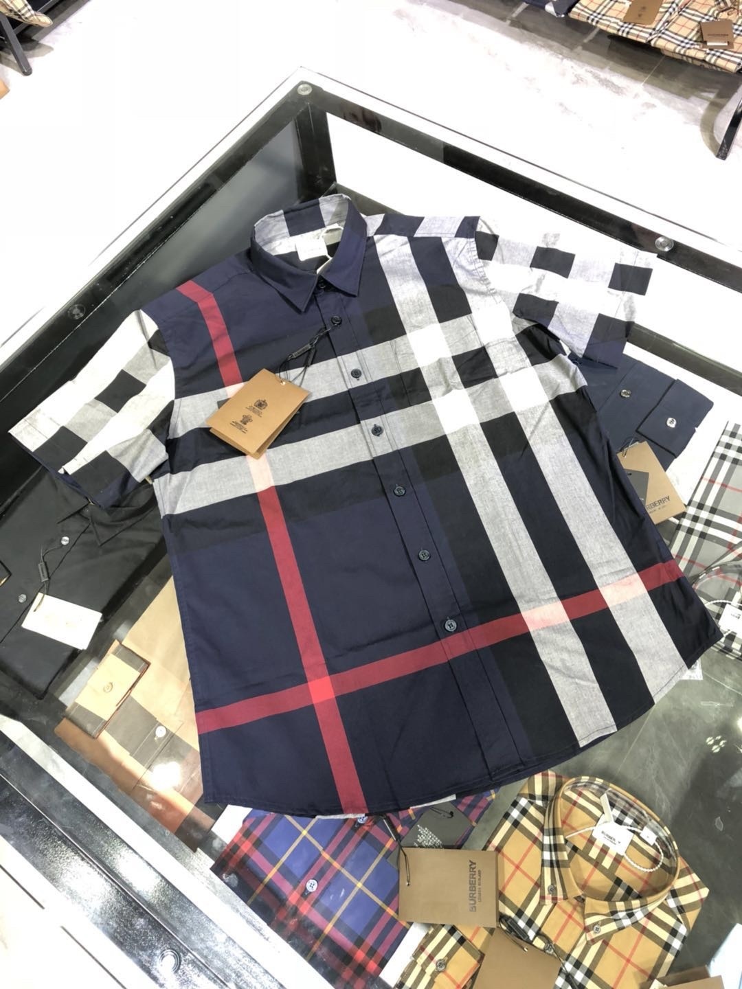 Burberry Check Cotton Flannel Shirt the signature check pattern in navy, red, gray, and white.