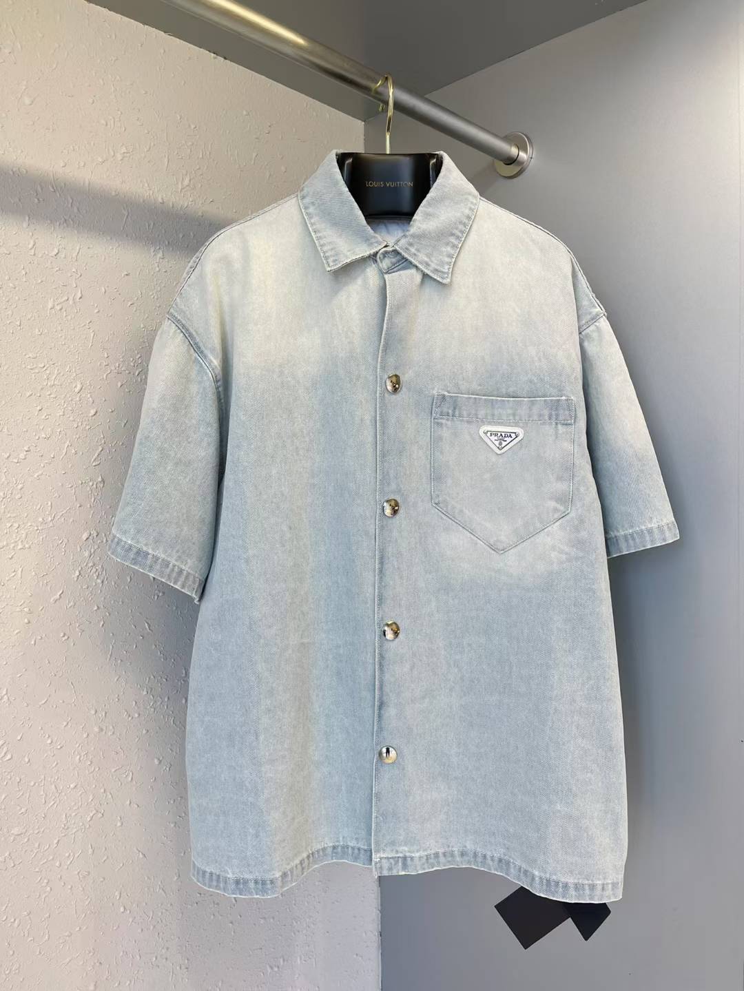 Prada short-sleeve denim shirt brand's iconic enameled metal triangle logo on the chest pocket