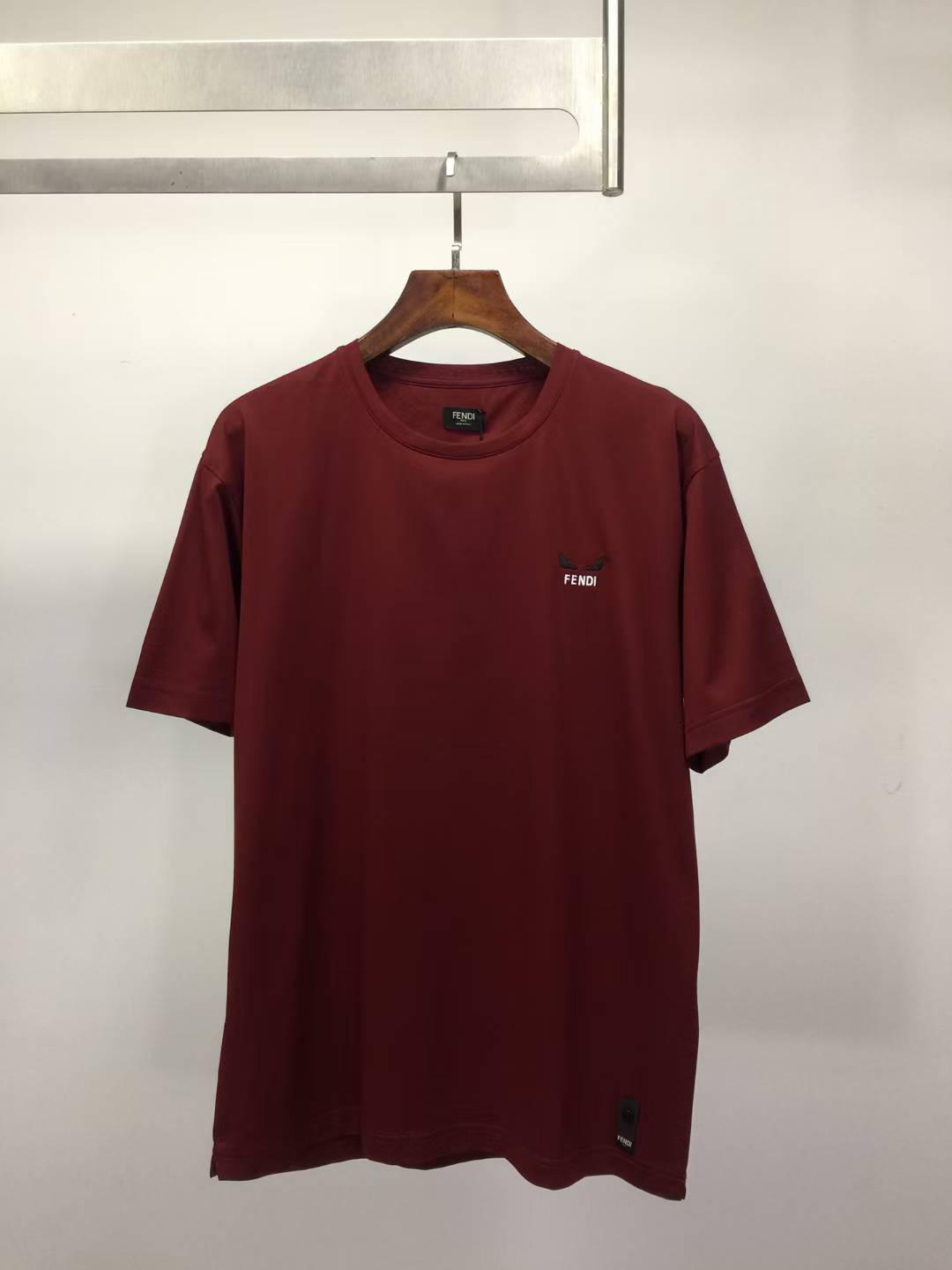 Fendi regular fit, short-sleeved, ribbed crew neck T-shirt in a rust or dark red color small embroidered logo on the chest