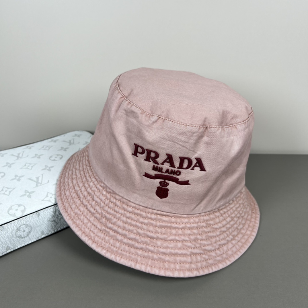 Prada nylon bucket hat in pale pink with a triangular logo patch