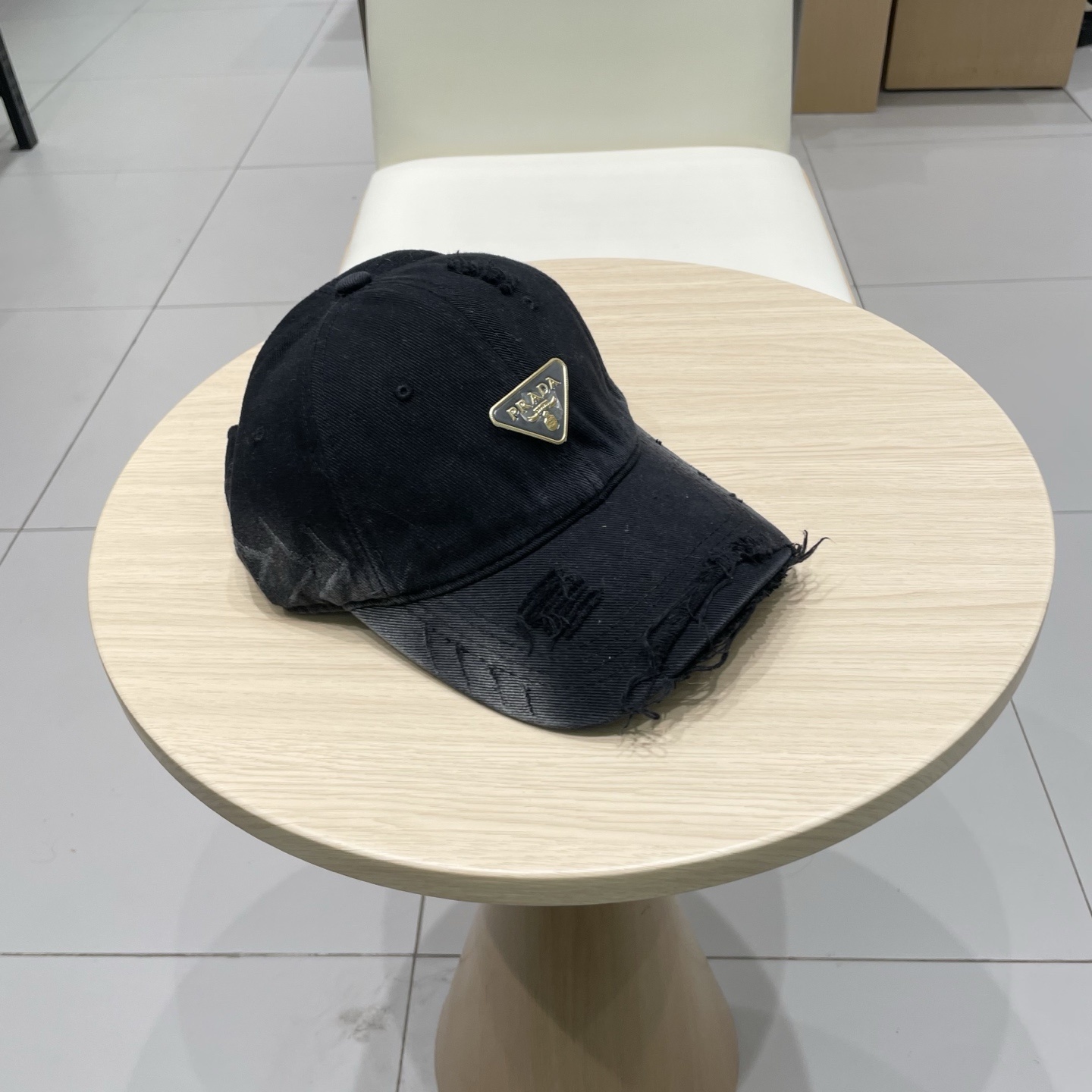 Prada cotton baseball cap with a used, distressed effect and the brand's iconic enamel triangle logo