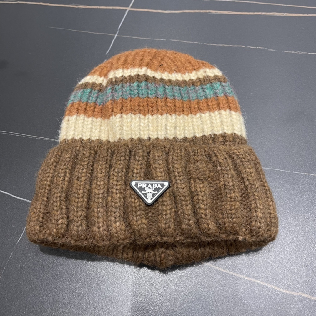 Prada wool and cashmere-blend ribbed-knit beanie in a brown, orange, and teal striped pattern