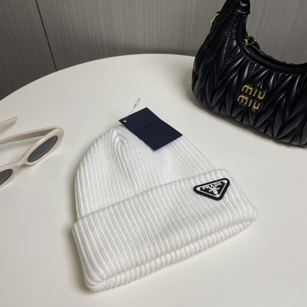 Prada wool and cashmere-blend beanie with an enameled metal triangle logo