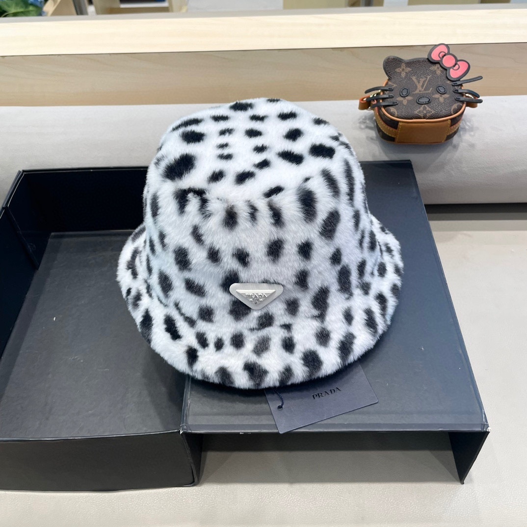 Prada print faux fur bucket hat with a Prada logo.