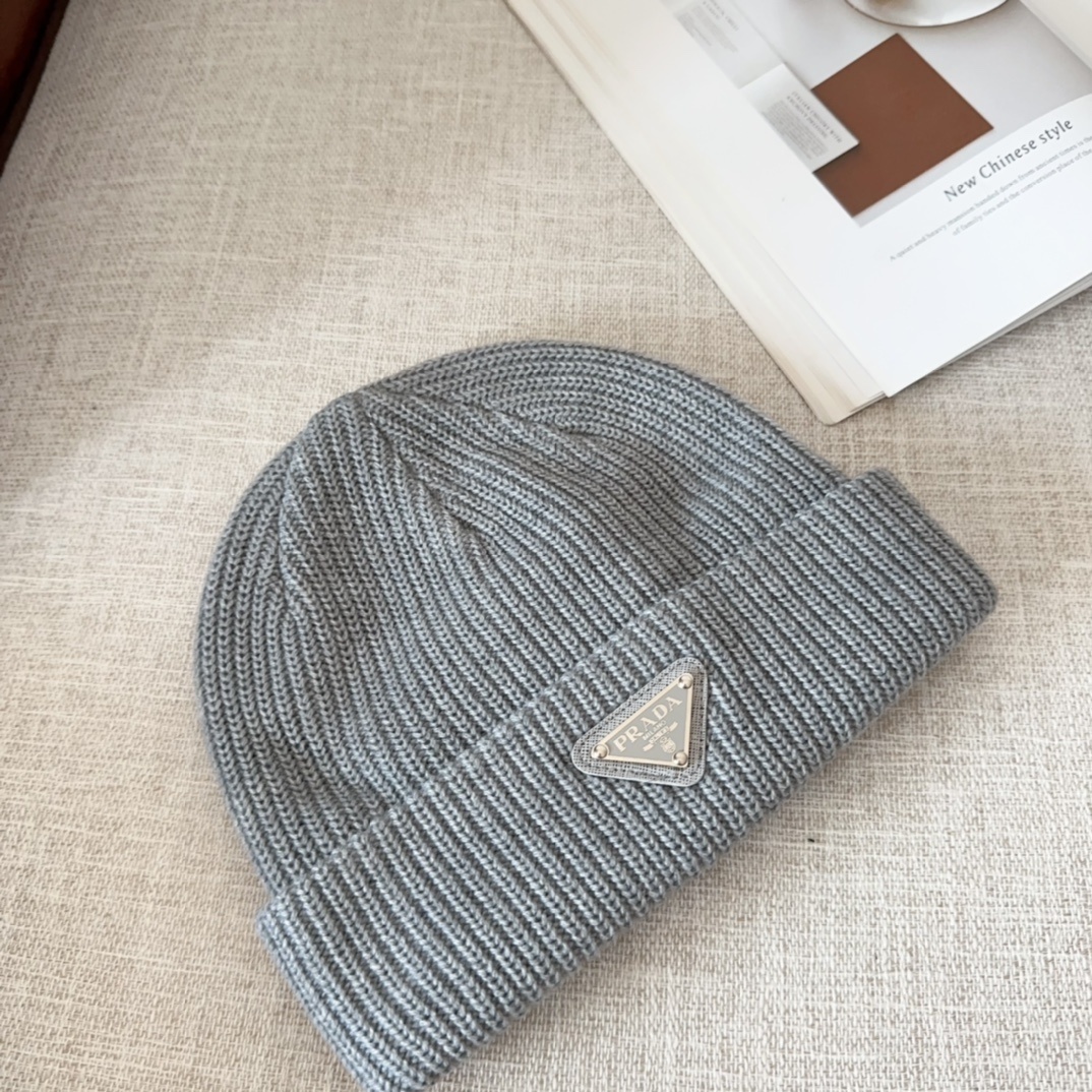 Prada virgin wool beanie with the iconic enameled metal triangle logo