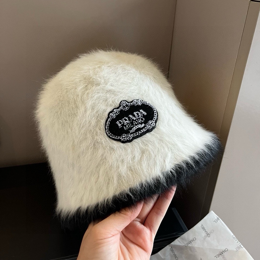 Prada shearling bucket hat in cream with black trim