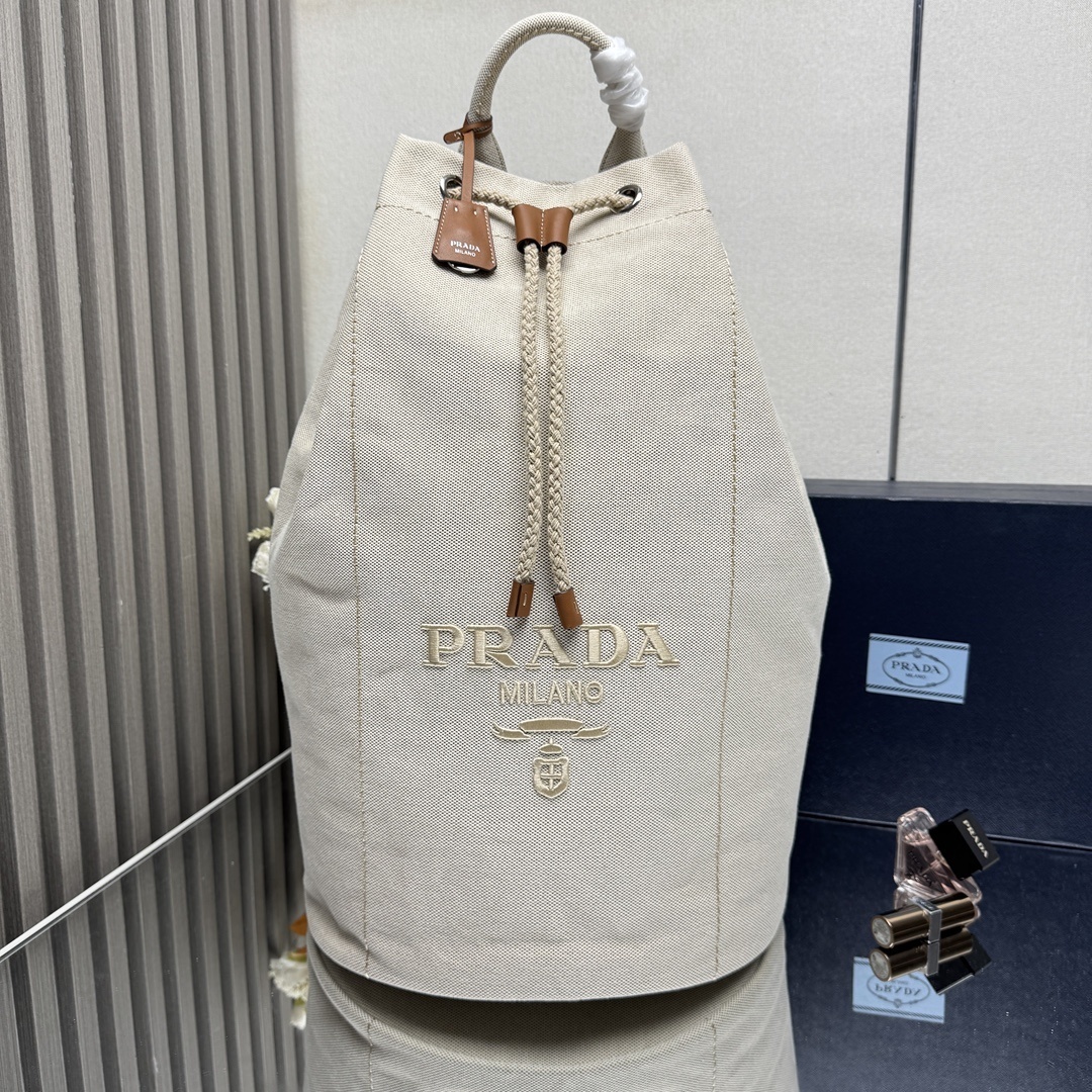 Prada linen-blend drawstring duffel bag in a natural color with leather details
