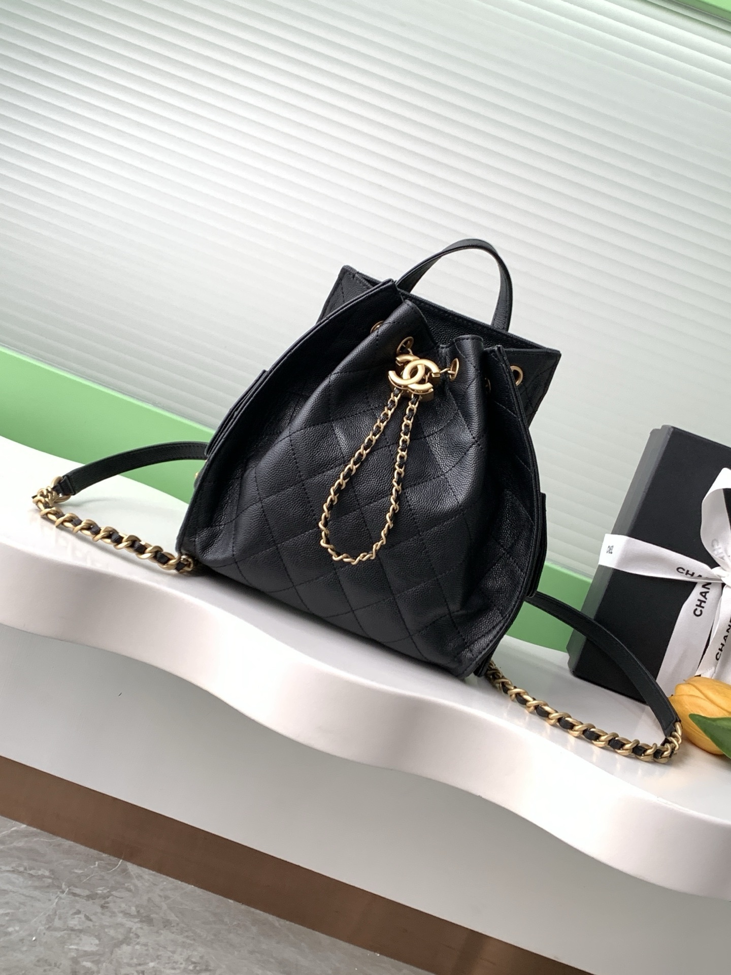 Chanel 25 backpack in black caviar leather with gold-tone hardware and a drawstring closure