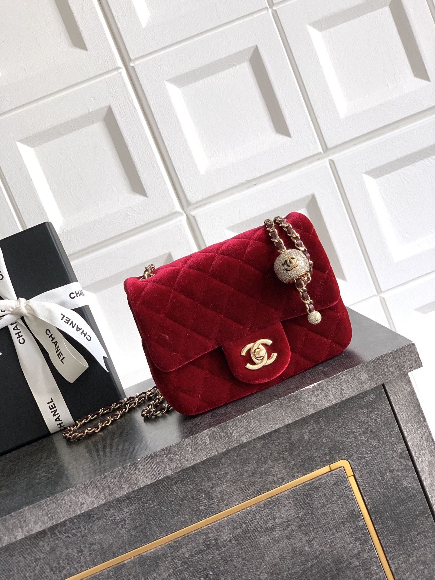 Chanel Pearl Crush Mini Square flap bag in burgundy velvet with gold-tone hardware and a crystal-embellished pearl ball on the adjustable strap