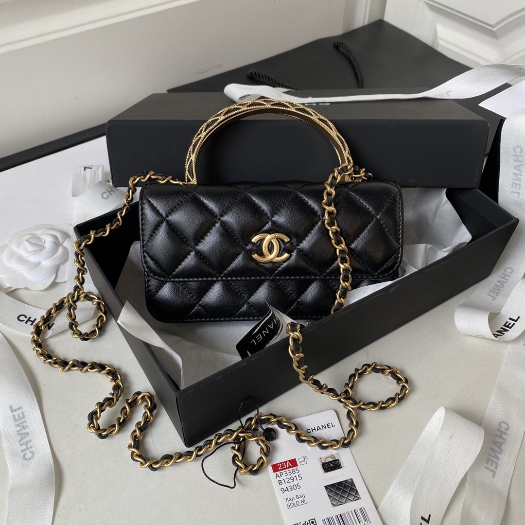 Chanel mini flap bag with top handle in black quilted lambskin leather with gold-tone hardware