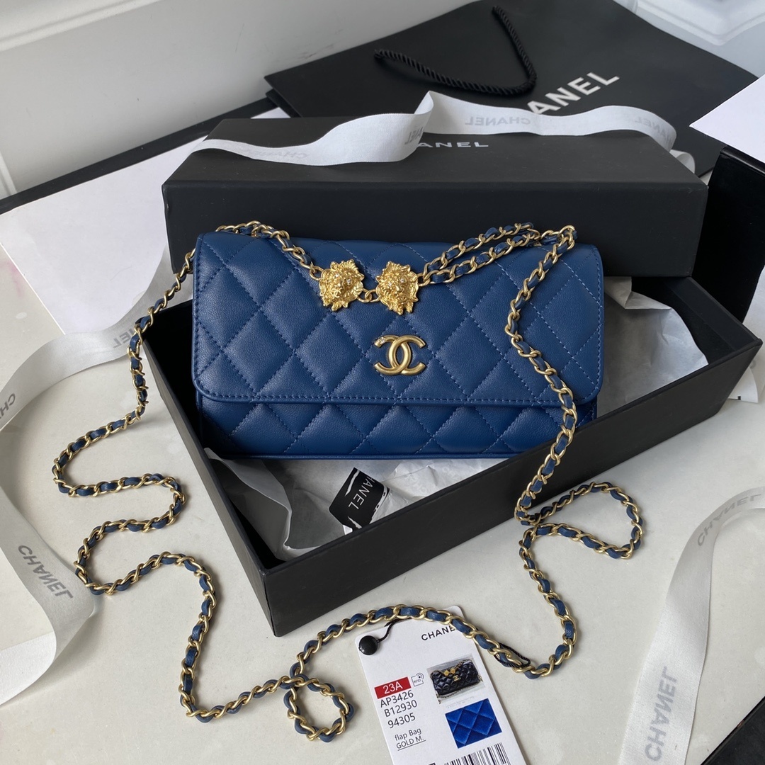 Chanel Wallet On Chain (WOC) bag with a gold-tone chain and lion head charm details