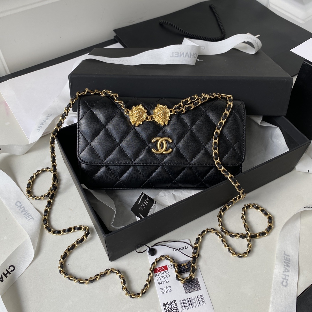 Chanel Flap Phone Holder With Chain in black caviar leather bag with gold hardware and a lion charm detail