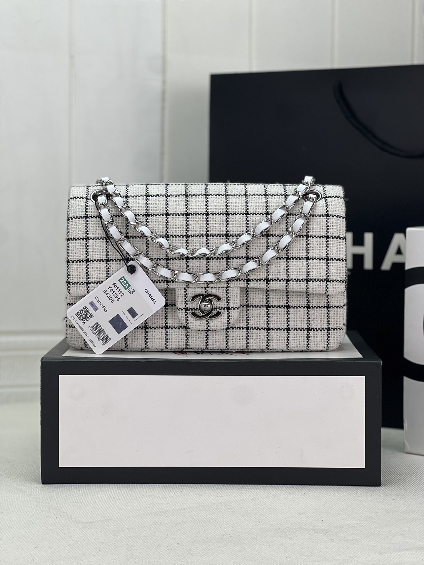 Chanel Classic 11.12 flap bag with a black and white checkerboard pattern
