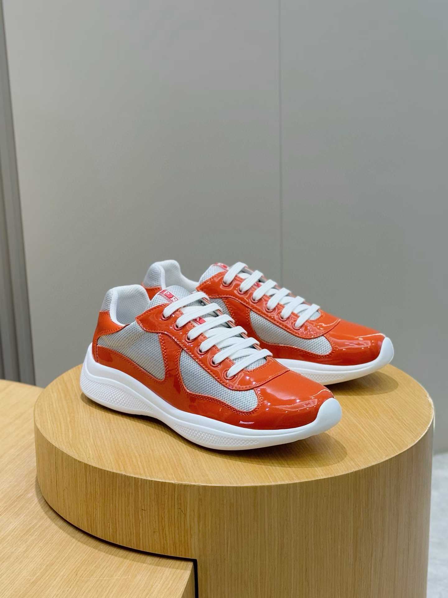 Prada America's Cup sneaker in orange patent leather and technical fabric with silver accents