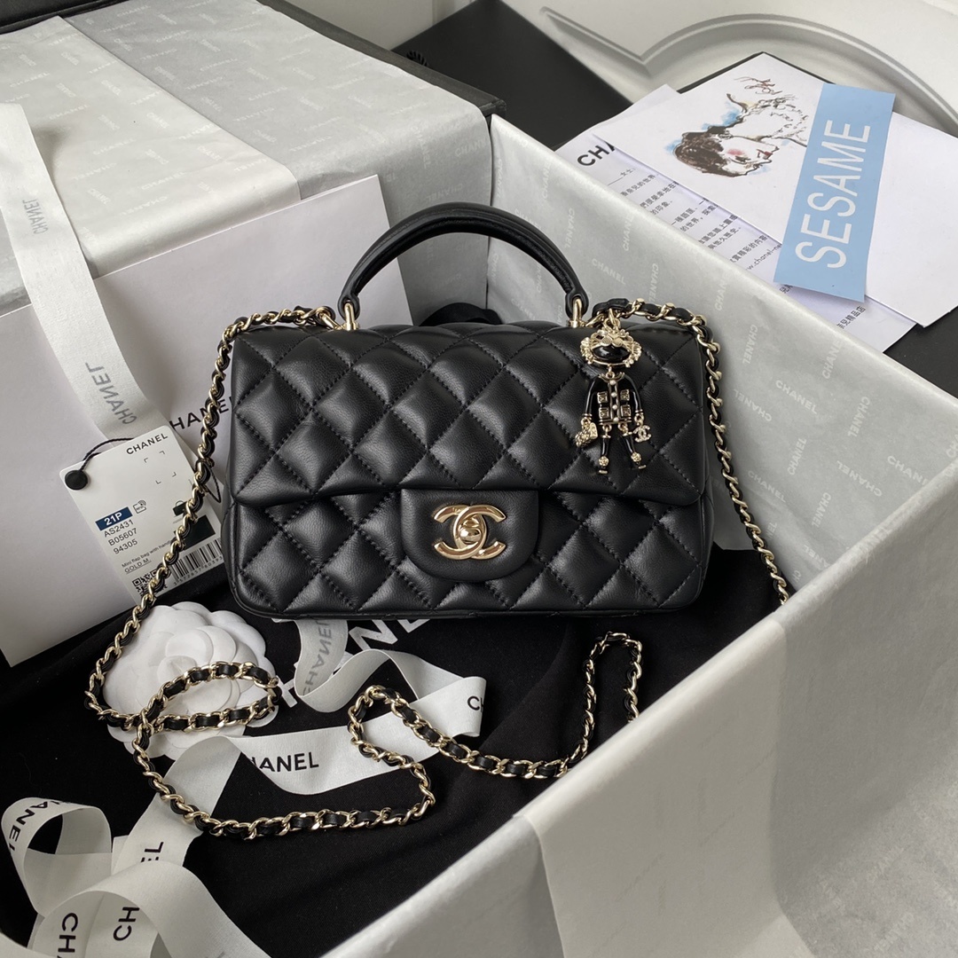 Chanel Mini Rectangular Top Handle Flap bag in black lambskin leather with a lion bag charm