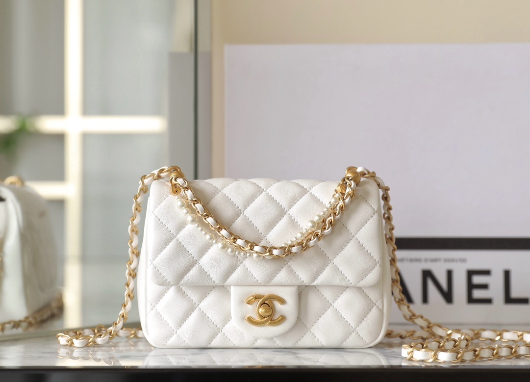 Chanel Mini Flap Bag in shiny lambskin, imitation pearls, and gold-tone metal