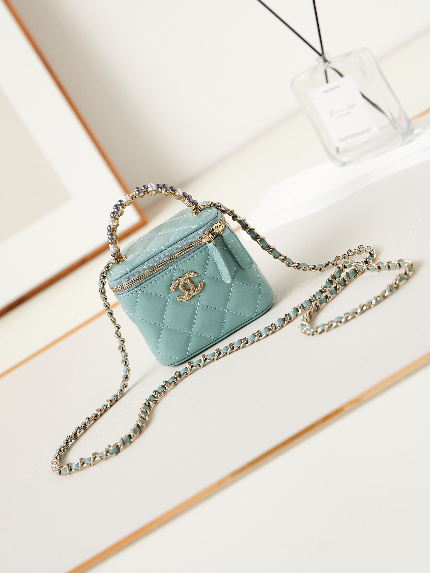 Chanel Mini Caviar Pearl On Top Vanity Case in a light blue or green shade