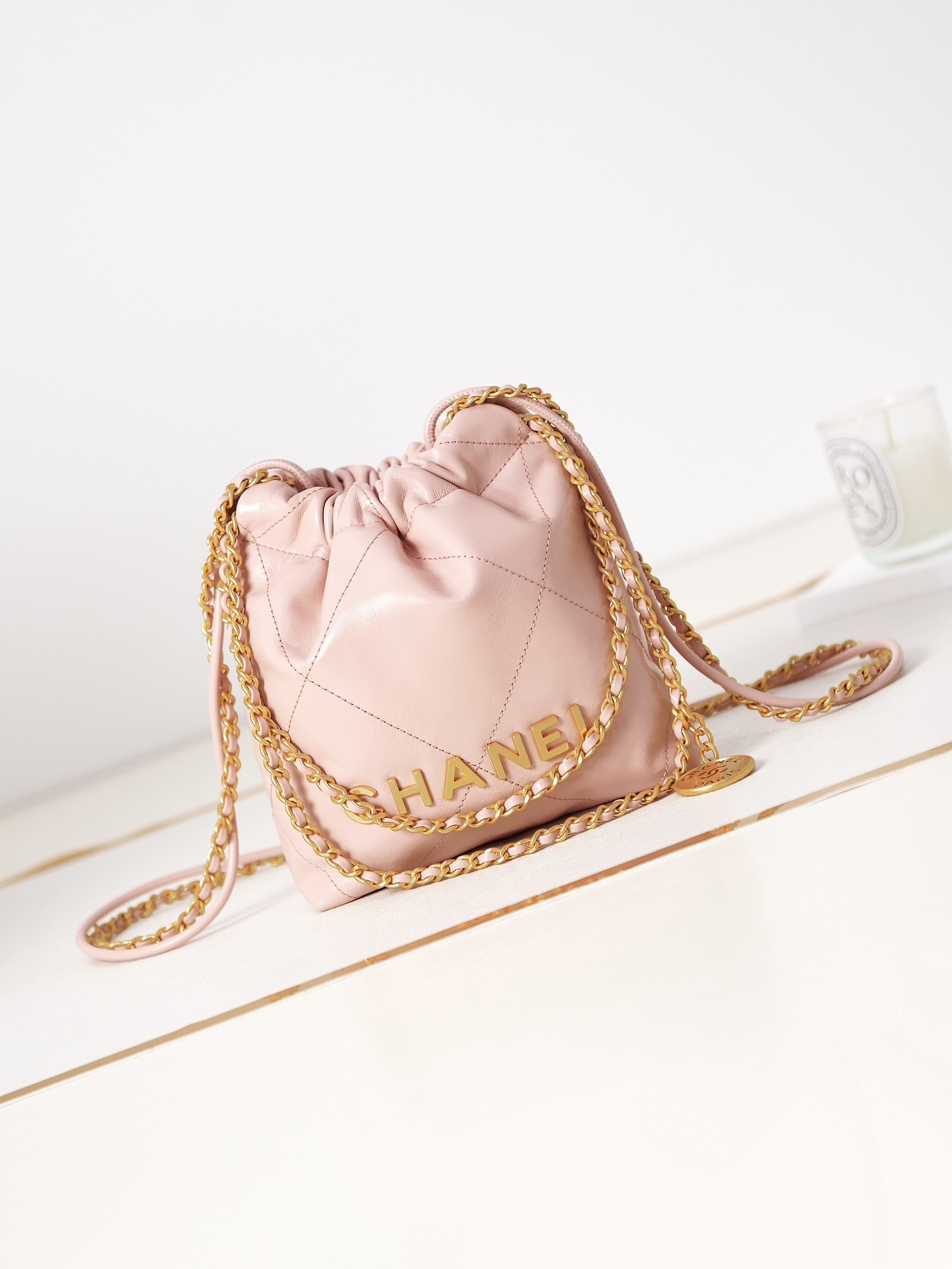 Chanel 22 mini handbag in light pink shiny calfskin leather with gold-tone metal hardware