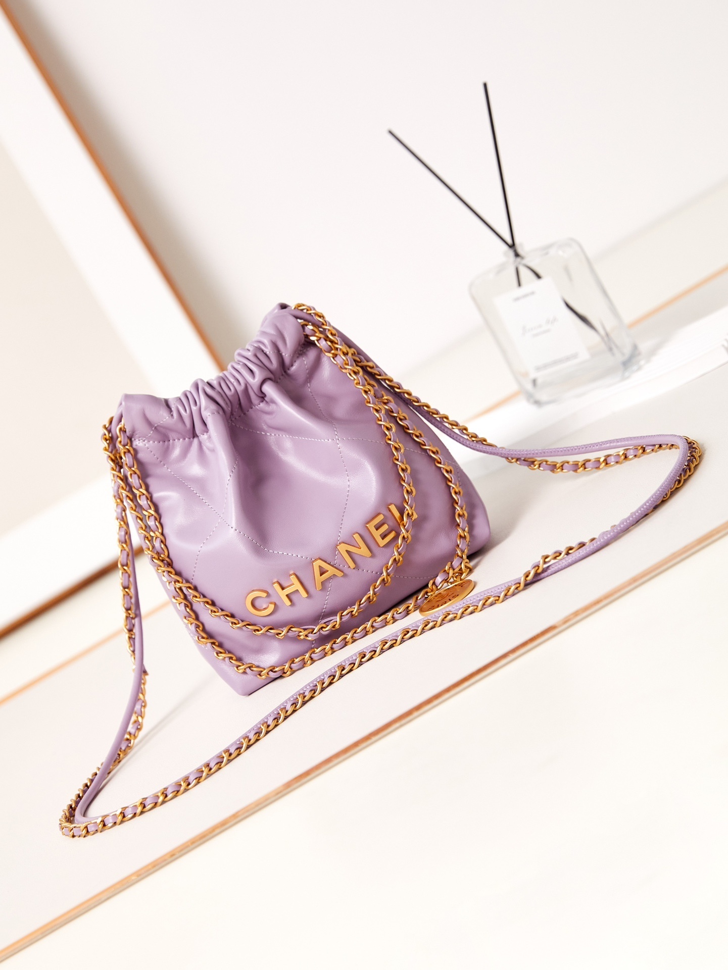 Chanel 22 mini handbag in shiny calfskin and gold-tone metal lavender color