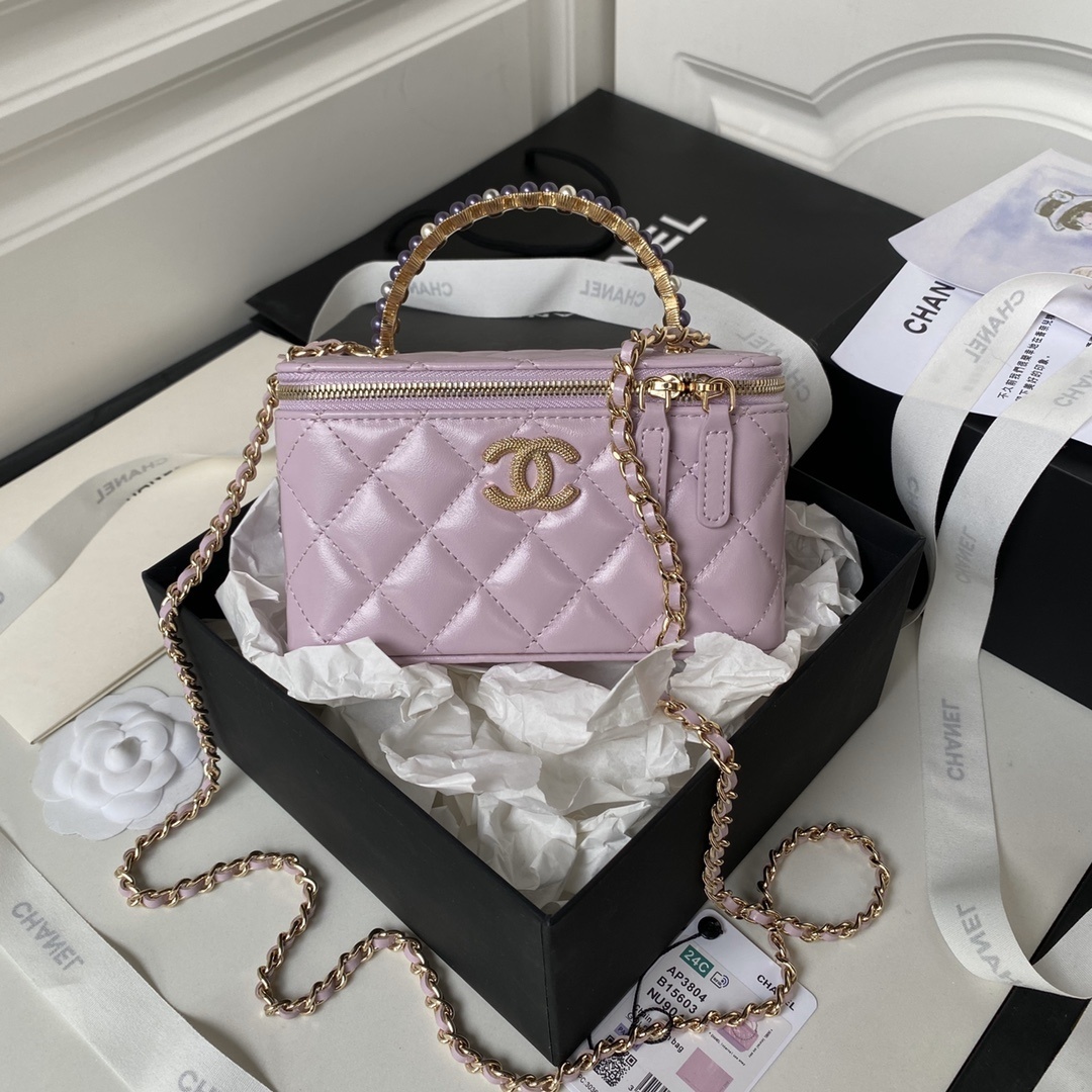 Chanel lambskin vanity bag with a pearl top handle and chain strap