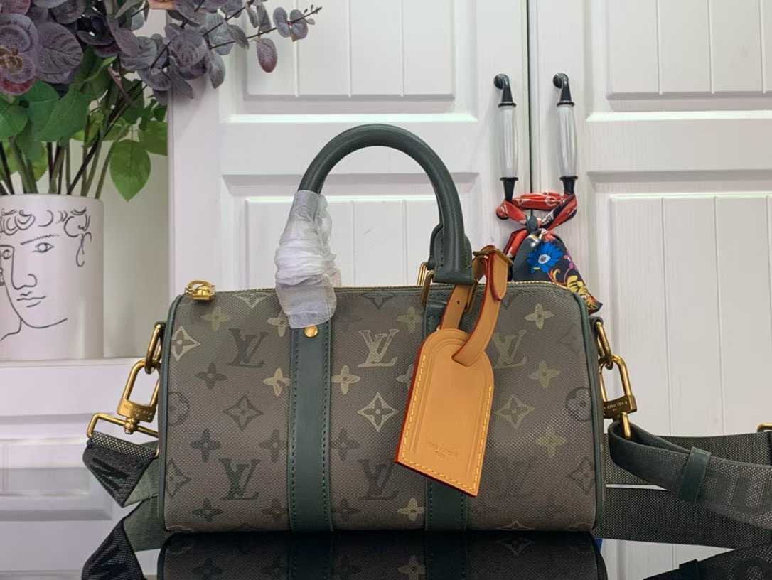 LV  Keepall Bandouliere 25 in Monogram Eclipse Reverse canvas with green leather trim.
