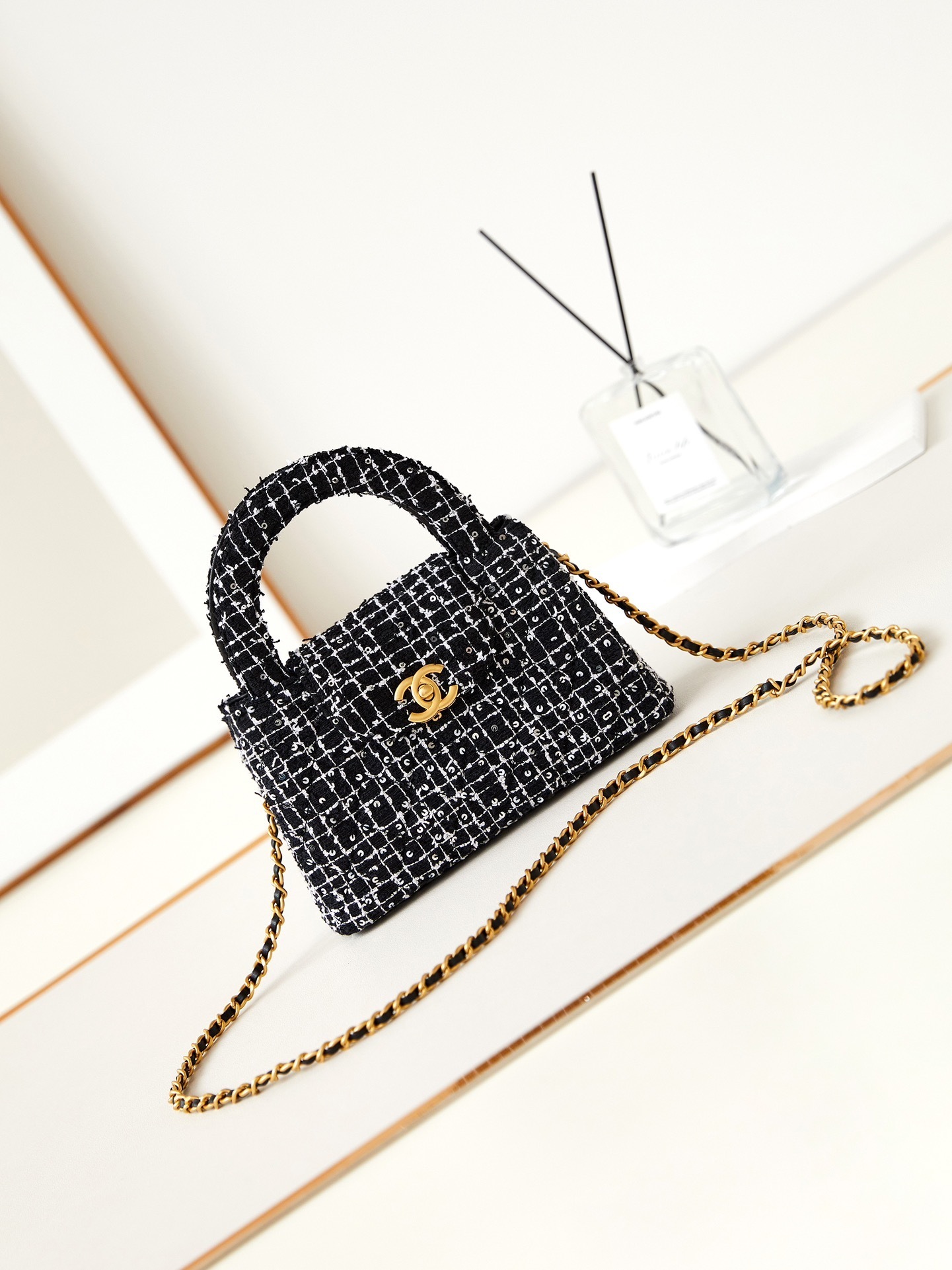 Chanel 24P Kelly Nano Shopping Bag in black and white tweed with aged gold hardware