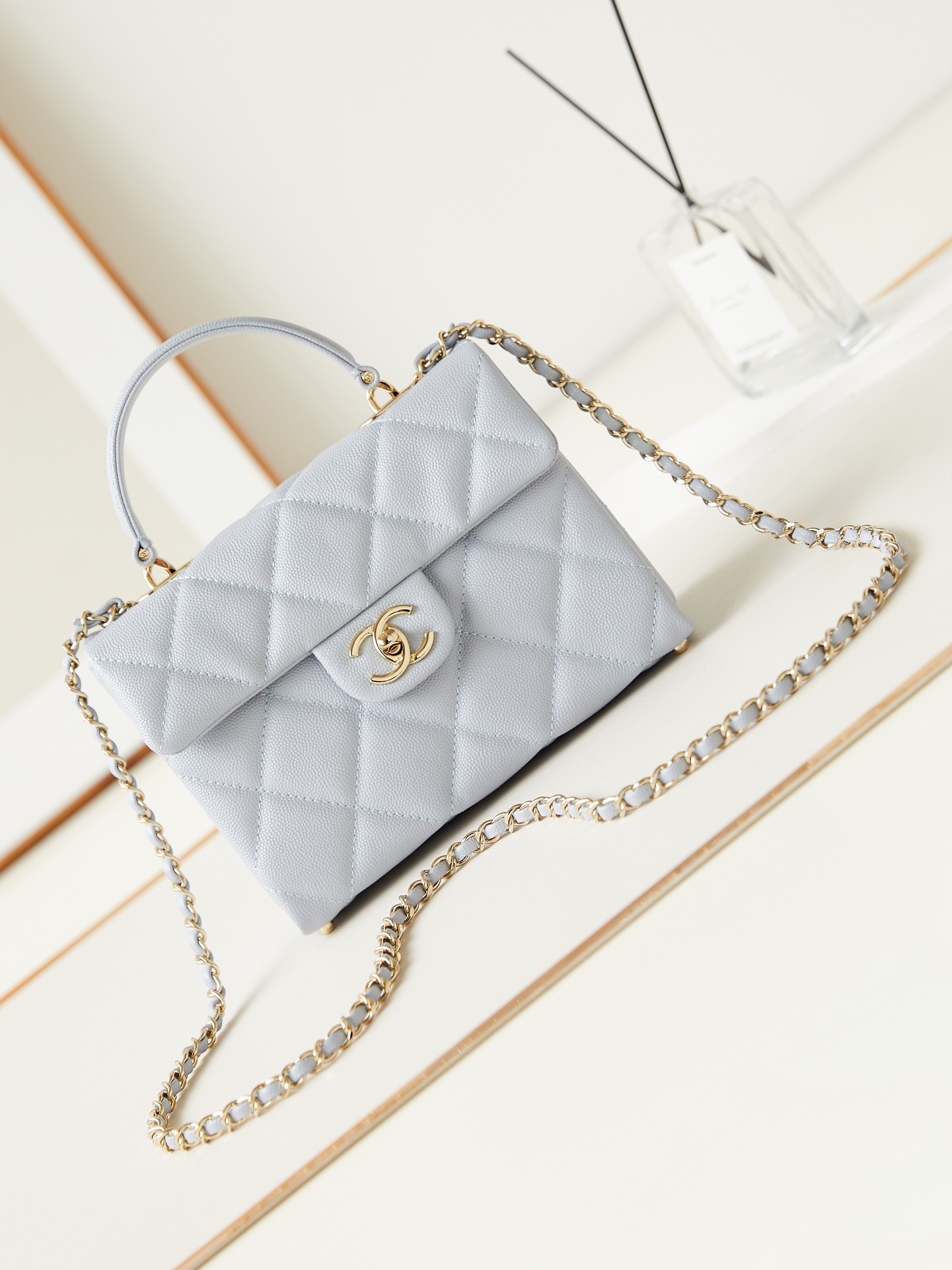 Chanel 24P Retrofit Flap bag in a light blue or grey caviar leather.