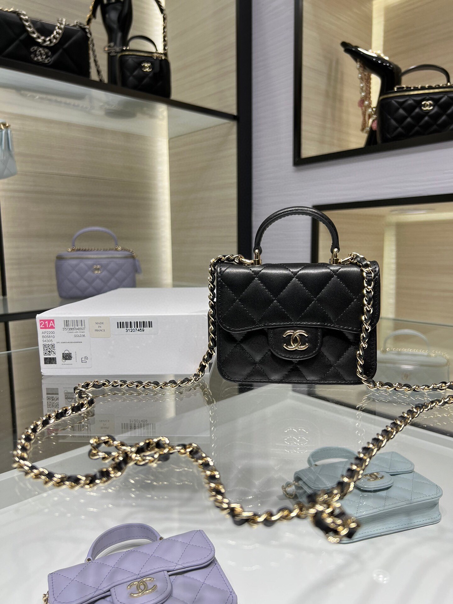 Chanel Mini Flap Bag with Top Handle in black lambskin leather