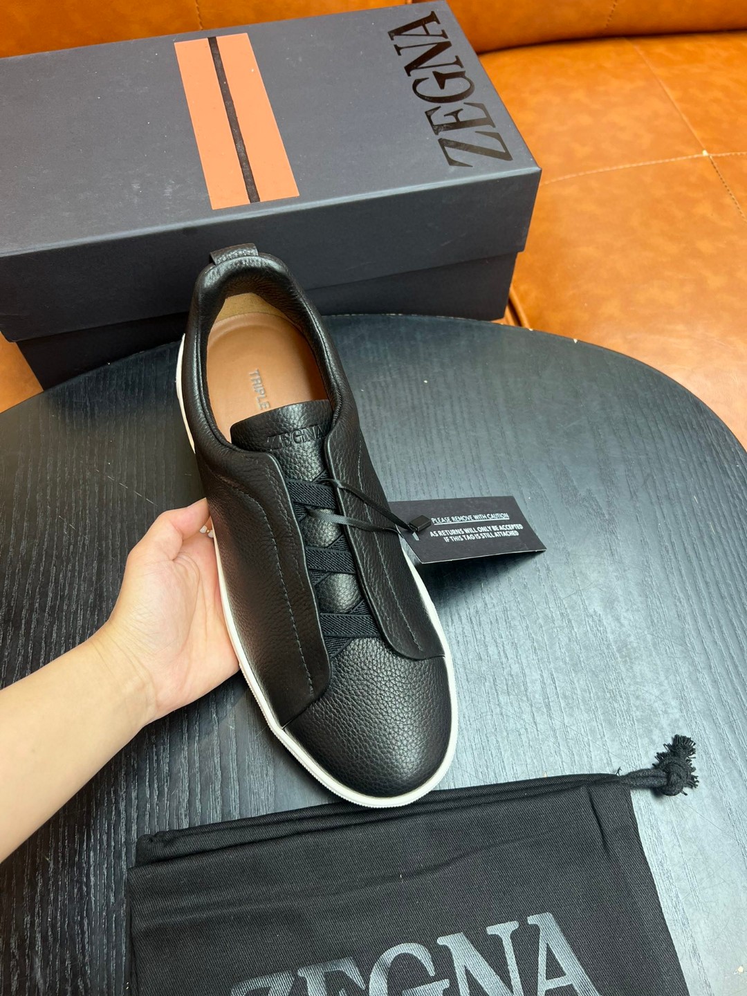 Zegna Deerskin Triple Stitch low-top slip-on sneaker in black with a white rubber sole.