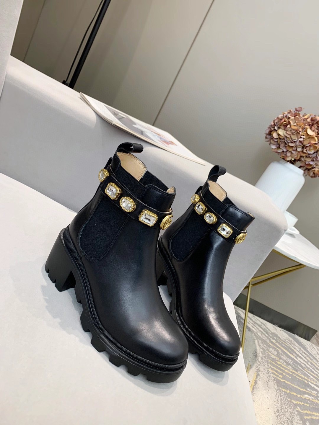 Gucci Black ankle boot with a jeweled strap and lug sole