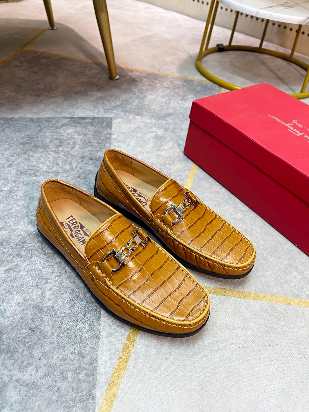 Ferragamo Gancini-buckle loafers in textured calfskin leather and a brown/tan color