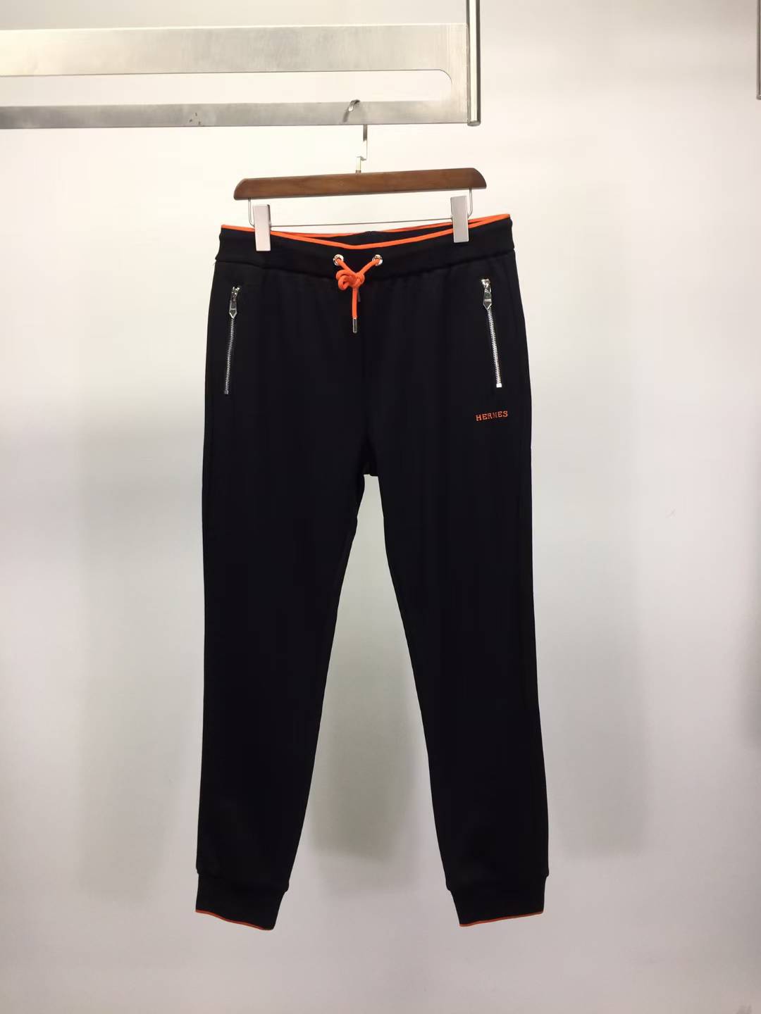 Hermes black cotton track pants with an orange drawstring and zipper pockets