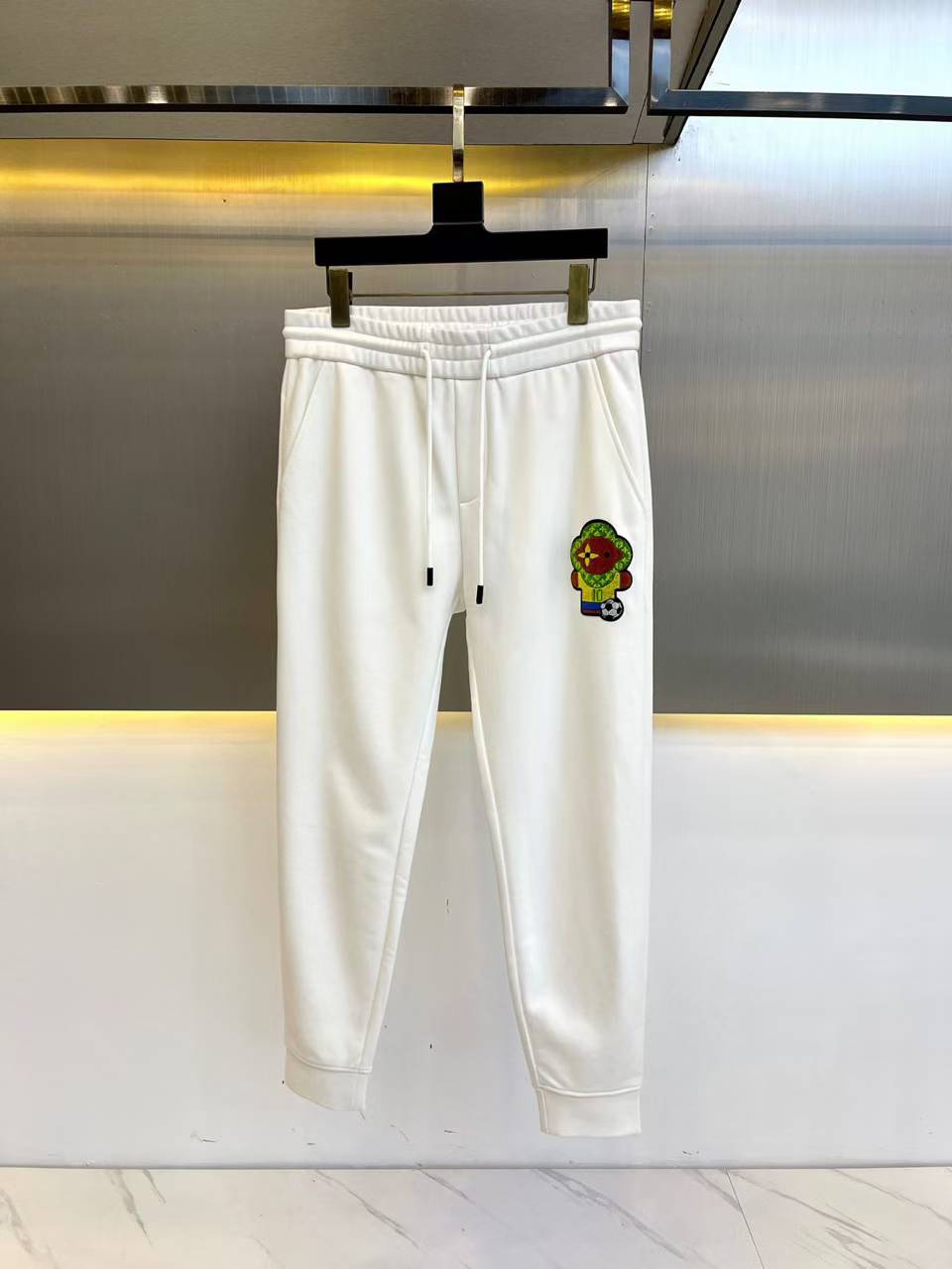 LV white graphic printed relaxed-fit mid-rise pair of joggers with an elasticated waistband and drawstring closure