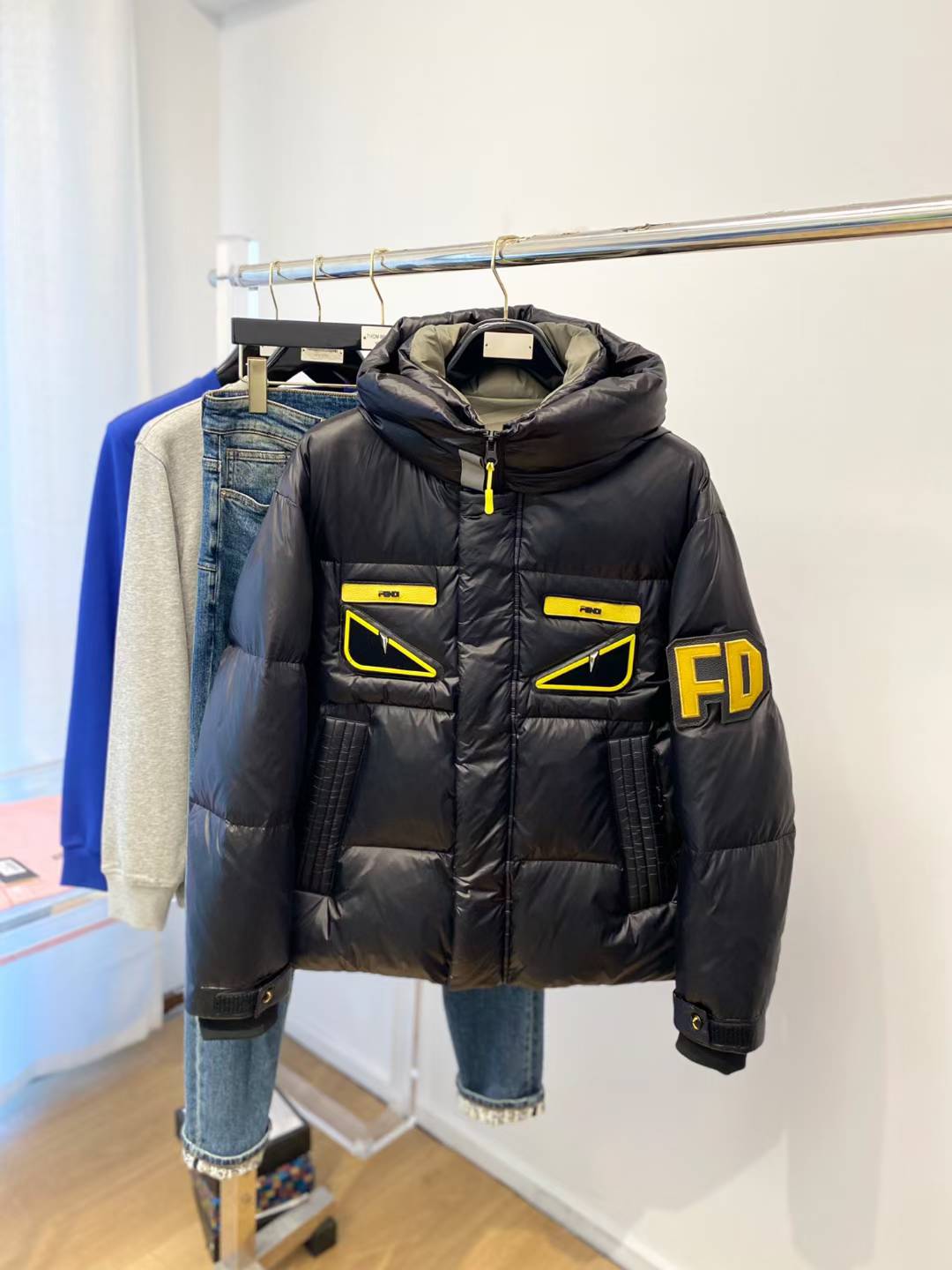 Fendi Monster Eyes print down puffer jacket in black with yellow accents