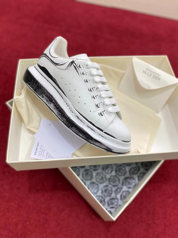 Alexander McQueen Oversized Sneaker in white calfskin leather with a black "shoe-on-shoe" print on the oversized rubber sole