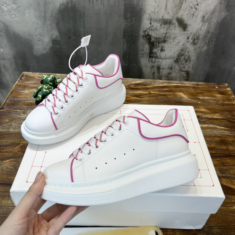 Alexander McQueen Oversized Sneaker with a white leather upper and a pink/bordeaux accent and laces