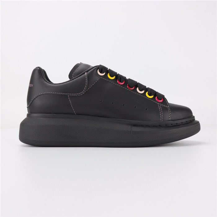 Alexander McQueen Oversized Sneaker in black leather with rainbow eyelets.