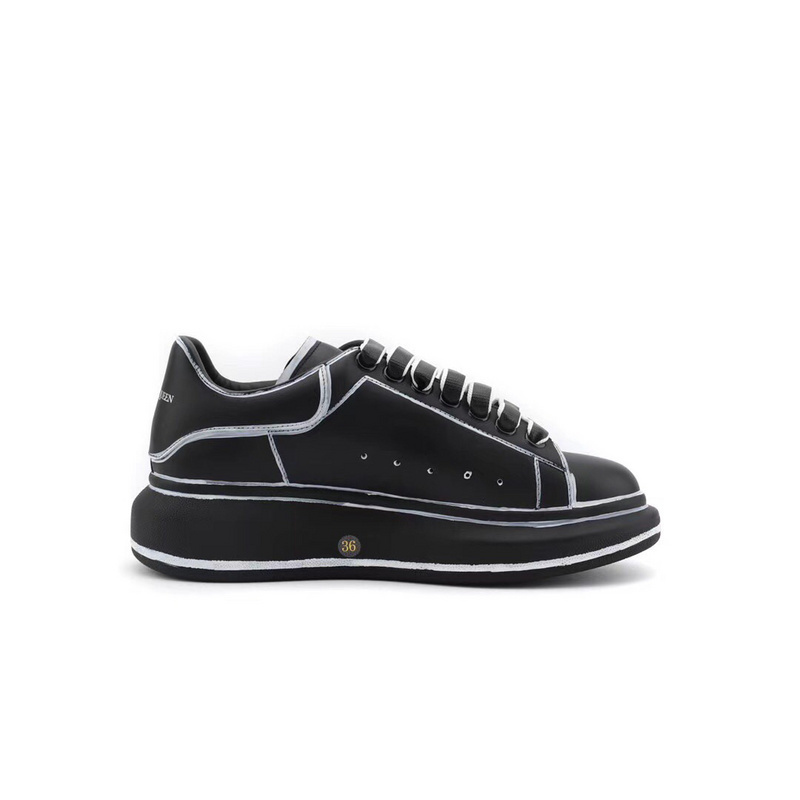 Alexander McQueen Oversized sneaker in black calf leather with white trim and an oversized rubber sole