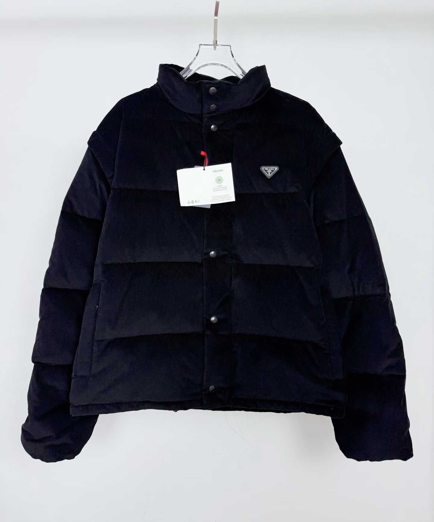 Prada black cotton corduroy puffer jacket with a stand-up collar and the signature enamel triangle logo