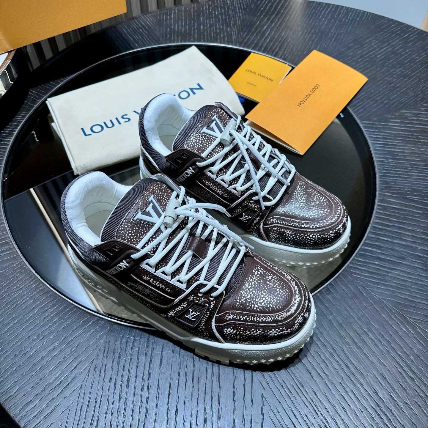 LV Trainer sneaker in a brown and white colorway featuring the signature Monogram pattern