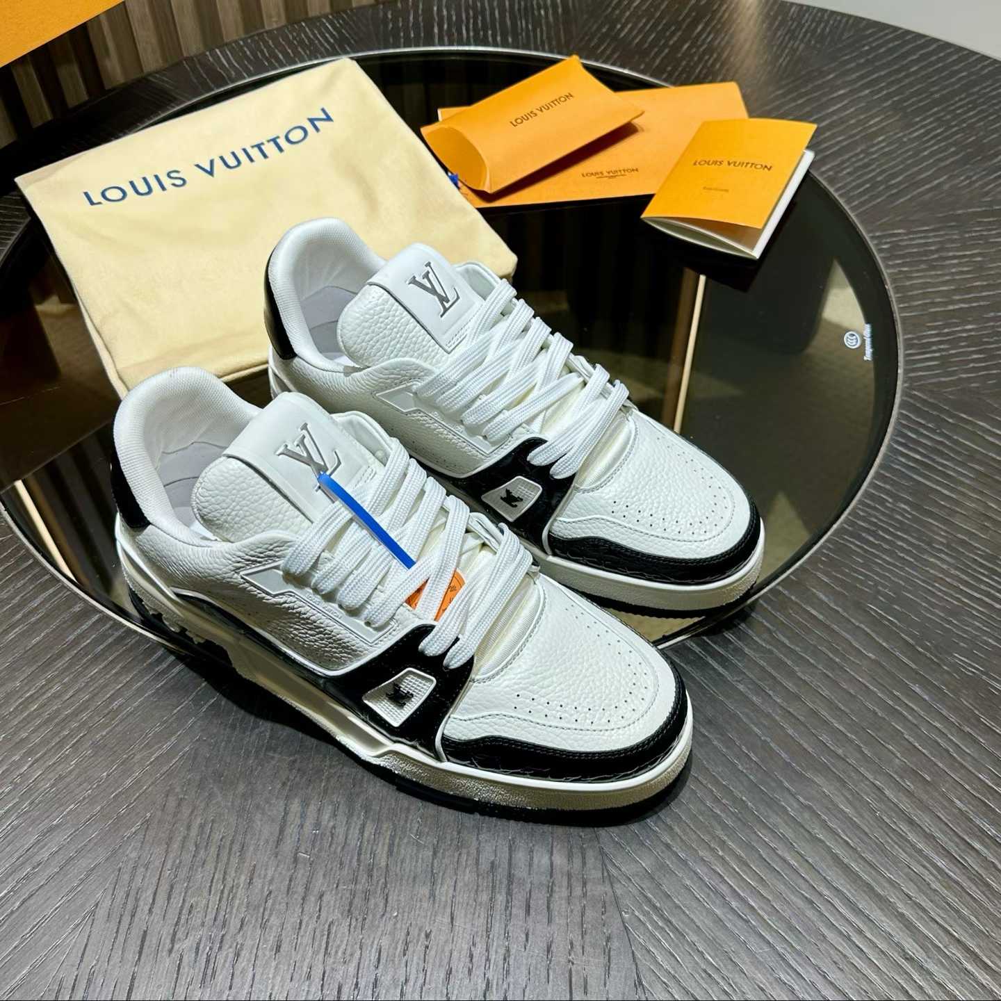 LV Trainer sneaker in white and black monogram denim and grained calf leather.