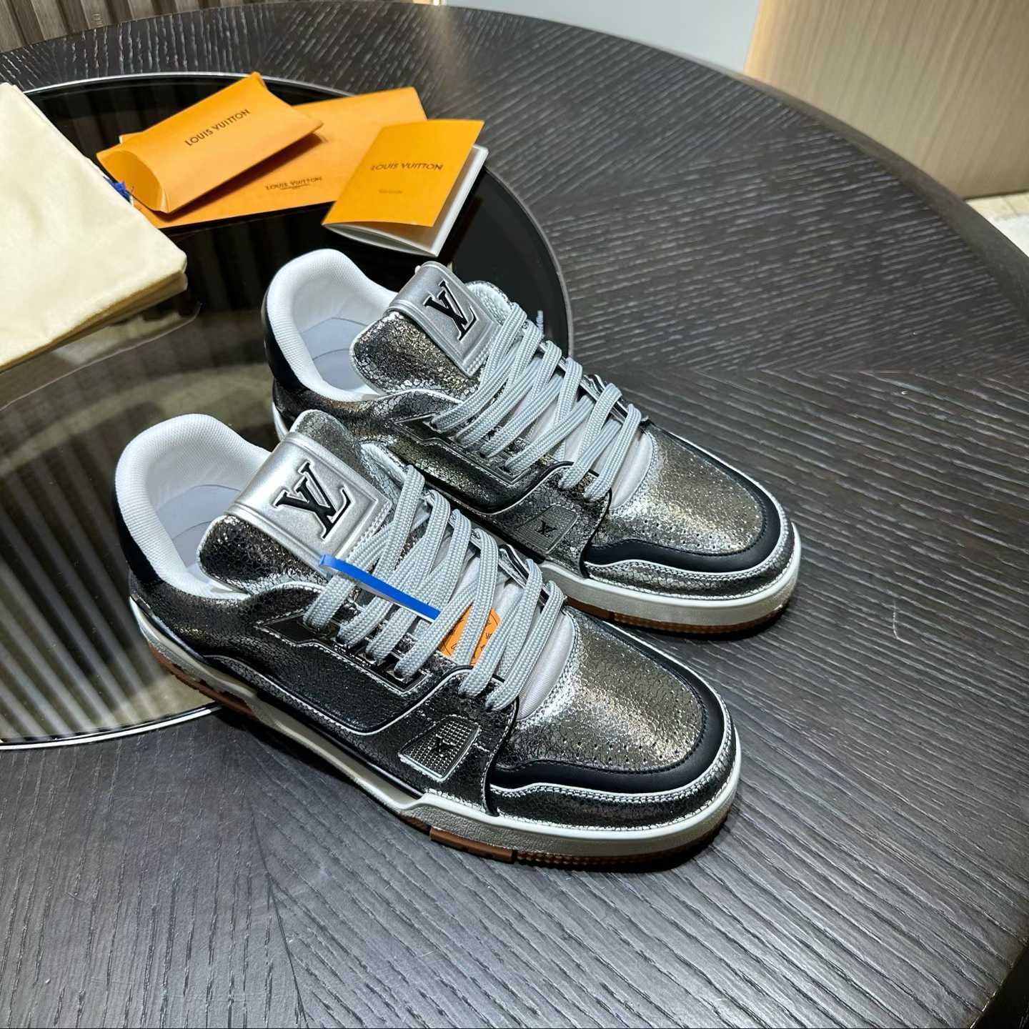 LV Trainer sneaker in a silver-toned, distressed-effect metallic leather finish